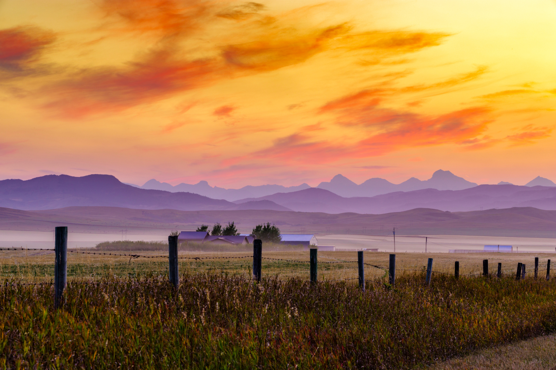 Farm in the rocky mountain foothills of rural Alberta during sunset
